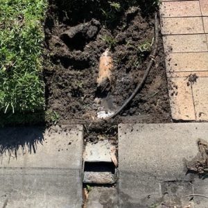 Stormwater to curb connection excavated and repaired