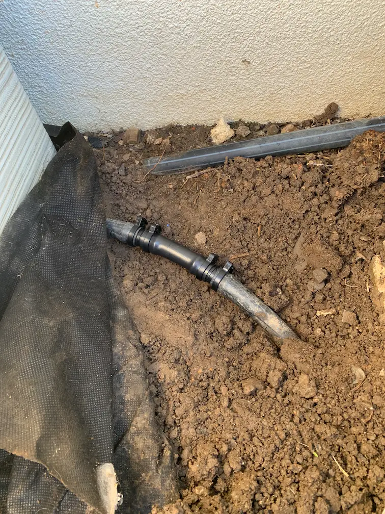 A professionally repaired irrigation system with a new PVC pipe section securely fitted in Box Hill.